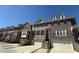 A row of elegant townhomes, each with a private garage and inviting entry staircase at 4121 Townsend Ln, Atlanta, GA 30346