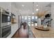Gourmet kitchen with stainless steel appliances, granite countertops, and open layout to dining area at 4121 Townsend Ln, Atlanta, GA 30346