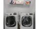 A laundry room with front load washer and dryer with shelving above at 4121 Townsend Ln, Atlanta, GA 30346