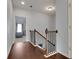 A beautiful interior stairway with stained handrail and hardwood floors at 4121 Townsend Ln, Atlanta, GA 30346