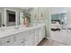 Spacious bathroom with a double sink vanity, neutral color scheme, and view of bedroom at 604 Blue Sky Blvd, Acworth, GA 30102