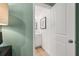 Modern half bathroom with a white vanity, mirror, and sleek fixtures at 604 Blue Sky Blvd, Acworth, GA 30102
