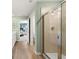 Bright bathroom features a glass enclosed walk-in shower and wood-look flooring at 604 Blue Sky Blvd, Acworth, GA 30102