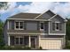 Charming two-story home featuring blue siding, decorative shutters, and an attached two-car garage at 604 Blue Sky Blvd, Acworth, GA 30102