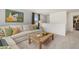Comfortable living room featuring a sectional couch, natural light, and artwork at 604 Blue Sky Blvd, Acworth, GA 30102