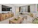 Comfortable carpeted living room area featuring a large TV and sectional couch at 604 Blue Sky Blvd, Acworth, GA 30102