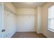 Walk-in closet with wire shelving, neutral walls, and a window for natural light at 4033 Roxberry Hill Ln, Buford, GA 30518