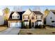 Charming two-story home featuring a stone facade, a two-car garage, and well-maintained landscaping at 4033 Roxberry Hill Ln, Buford, GA 30518