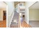 Inviting foyer featuring a staircase, wood floors, and views into the living room and dining area at 4033 Roxberry Hill Ln, Buford, GA 30518