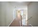 Upstairs hallway with carpet flooring, white trim and doors with a view of the bathroom at 4033 Roxberry Hill Ln, Buford, GA 30518