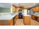 Traditional kitchen with stainless steel appliances, wood cabinetry, and an island with white countertops at 4033 Roxberry Hill Ln, Buford, GA 30518