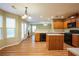 Open-concept kitchen with stainless steel appliances flows into a dining area with a fireplace at 4033 Roxberry Hill Ln, Buford, GA 30518