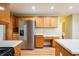 Spacious kitchen features stainless steel refrigerator, ample wood cabinets, and a built-in desk area at 4033 Roxberry Hill Ln, Buford, GA 30518