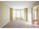 Cozy carpeted living room boasts a bay window for natural light, and neutral walls, creating an inviting space at 4033 Roxberry Hill Ln, Buford, GA 30518
