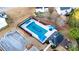 Aerial view of a community pool with a pool house, chairs, and mature landscaping at 4033 Roxberry Hill Ln, Buford, GA 30518
