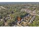 Overhead view of a property surrounded by many mature trees in a suburban neighborhood at 4950 Luke Dr, Cumming, GA 30040