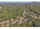 Scenic aerial shot shows homes surrounded by lush trees, highlighting the serene neighborhood setting at 4950 Luke Dr, Cumming, GA 30040