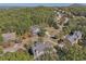 Stunning aerial view of homes surrounded by lush trees and greenery, with mountain views in the distance at 4950 Luke Dr, Cumming, GA 30040