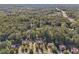 Beautiful aerial shot displays several homes nestled in a tree-filled landscape with a view of a highway at 4950 Luke Dr, Cumming, GA 30040
