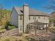 An outdoor living space featuring a stone patio with a pergola, a fenced yard, and mature trees at 4950 Luke Dr, Cumming, GA 30040