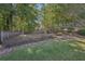 Secluded backyard with tiered landscaping, creating a peaceful and private oasis at 4950 Luke Dr, Cumming, GA 30040