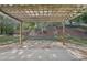 Backyard with a wooden pergola, stone patio, and lush greenery at 4950 Luke Dr, Cumming, GA 30040
