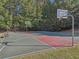 View of basketball court surrounded by mature trees in a residential community at 4950 Luke Dr, Cumming, GA 30040