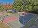 Community basketball court with two hoops, seating, and mature landscaping at 4950 Luke Dr, Cumming, GA 30040