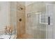 This bathroom features a tiled walk-in shower with glass doors and shower head at 4950 Luke Dr, Cumming, GA 30040