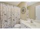 Cozy bathroom offering a decorative shower curtain and ornamental wall decor above the toilet at 4950 Luke Dr, Cumming, GA 30040