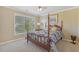 Traditional bedroom with a wooden four-poster bed bathed in natural light from a large window at 4950 Luke Dr, Cumming, GA 30040