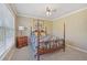 Charming bedroom featuring natural light and a classic wooden four-poster bed at 4950 Luke Dr, Cumming, GA 30040