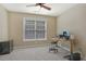 Neutral bedroom featuring a ceiling fan, a window with blinds and space for a desk at 4950 Luke Dr, Cumming, GA 30040