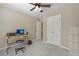 Bedroom featuring closet, fan, a work desk and carpet flooring at 4950 Luke Dr, Cumming, GA 30040