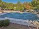 An aerial view of the community pool area, highlighting its size, fencing, and surrounding landscaping at 4950 Luke Dr, Cumming, GA 30040