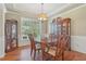 Refined dining room with classic china cabinet, a round table, and picture window for a bright, inviting atmosphere at 4950 Luke Dr, Cumming, GA 30040