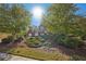 Beautiful two-story home surrounded by mature trees, set on a manicured lawn at 4950 Luke Dr, Cumming, GA 30040