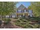 Charming two-story home with brick and siding, featuring a manicured lawn and mature trees at 4950 Luke Dr, Cumming, GA 30040