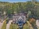 Two-story home with manicured lawn and driveway, nestled in a neighborhood with mature trees at 4950 Luke Dr, Cumming, GA 30040