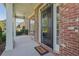 Charming covered porch with a welcoming doormat and elegant brick accents at 4950 Luke Dr, Cumming, GA 30040