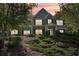 Two-story home with brick and siding, lush landscaping, and inviting front porch at 4950 Luke Dr, Cumming, GA 30040