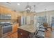 Well-appointed kitchen with island seating, stainless appliances, pendant lighting, and abundant cabinet space, perfect for chefs at 4950 Luke Dr, Cumming, GA 30040