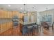 Modern kitchen with stainless steel appliances, granite island with bar seating, and adjacent breakfast area is perfect for gatherings at 4950 Luke Dr, Cumming, GA 30040