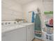 Functional laundry room featuring a Whirlpool washer and dryer, plus overhead shelving at 4950 Luke Dr, Cumming, GA 30040