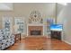 Living room with a brick fireplace, hardwood floors, and large windows at 4950 Luke Dr, Cumming, GA 30040