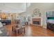 Open-concept living room with brick fireplace, hardwood floors, and soaring ceilings for a bright and airy feel at 4950 Luke Dr, Cumming, GA 30040