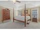 Large primary bedroom showcases a four-poster bed, tray ceiling, and carpeted floors at 4950 Luke Dr, Cumming, GA 30040