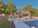 A covered outdoor living space is next to the expansive pool area, great for entertaining guests at 4950 Luke Dr, Cumming, GA 30040