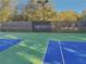 Community tennis courts with 'Ashbrooke' signage in a serene, wooded setting at 4950 Luke Dr, Cumming, GA 30040