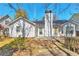 Rear exterior of home with a deck, showcasing its backyard and architectural details under a bright sky at 2220 Golden Valley Dr, Lawrenceville, GA 30043
